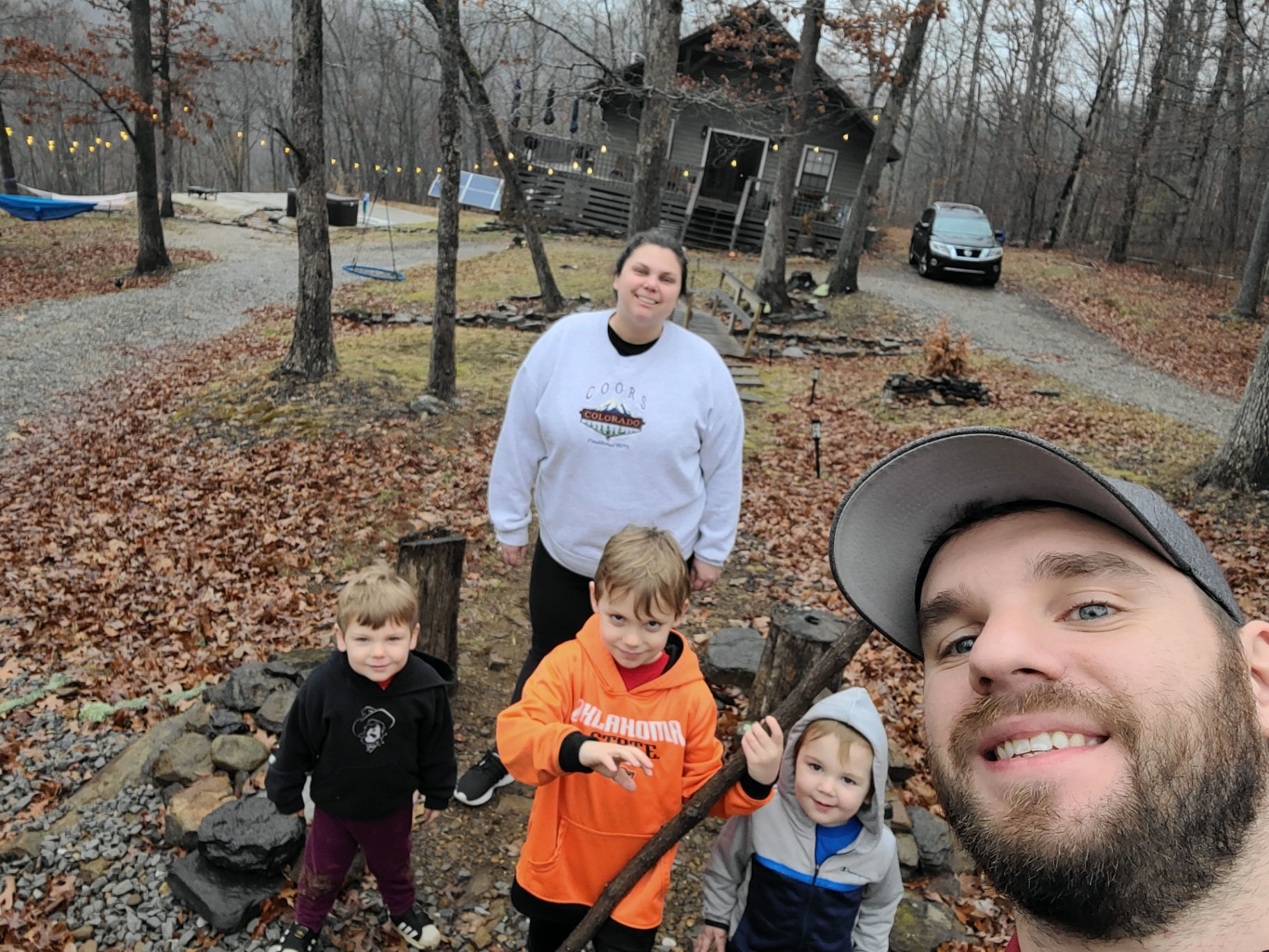 Hopper family outside a cabin in the woods